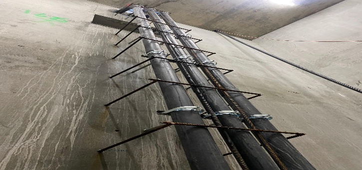 Vertical electrical conduit risers in shaft